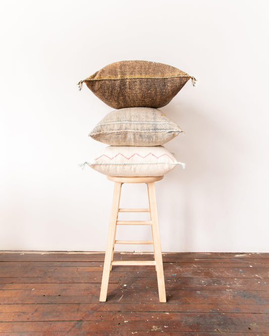 pillows stacked on stool