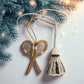 Decorative badminton racket and shuttlecock ornament hanging on a branch with lights.